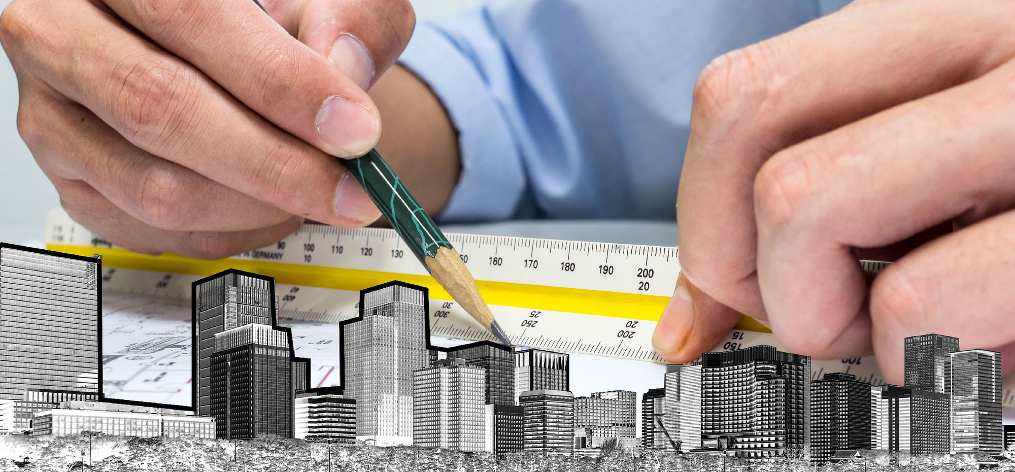 A pair of hand takes measurements from a drawing of a city of buildings