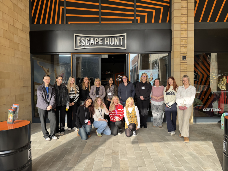 Women from GLP Training standing together for a group photo outside the Escape Hunt venue.